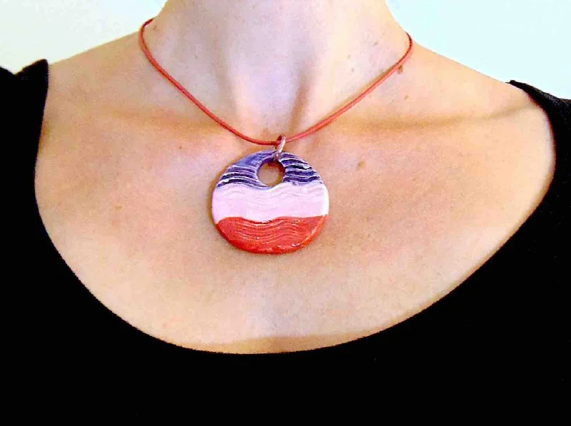 elegant necklaces for women -16-inch necklace with large round wavy ceramic pendant medallion handmade in Montreal in violet-pink-red, red leather cord, aluminum ring, stainless steel clasp