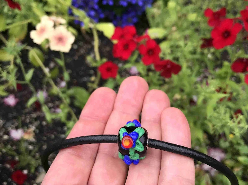 handmade necklaces for women -Choker necklace with black cylinder glass bead (Murano-style glass handmade in Montreal), 3-dimensional red-blue-green flowers, black leather cord, stainless steel clasp