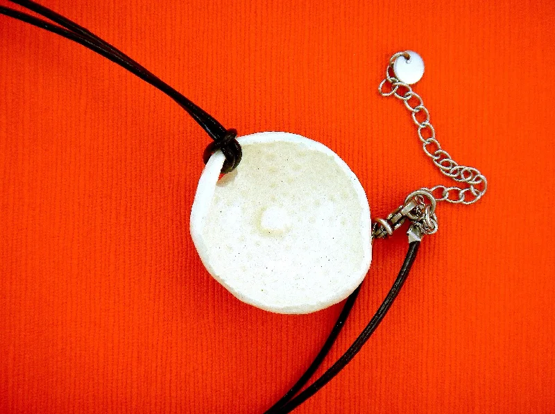 minimalistic silver necklaces for women -24-inch necklace with off-white ceramic sea urchin pendant handmade in Montreal, black leather cord, stainless steel clasp